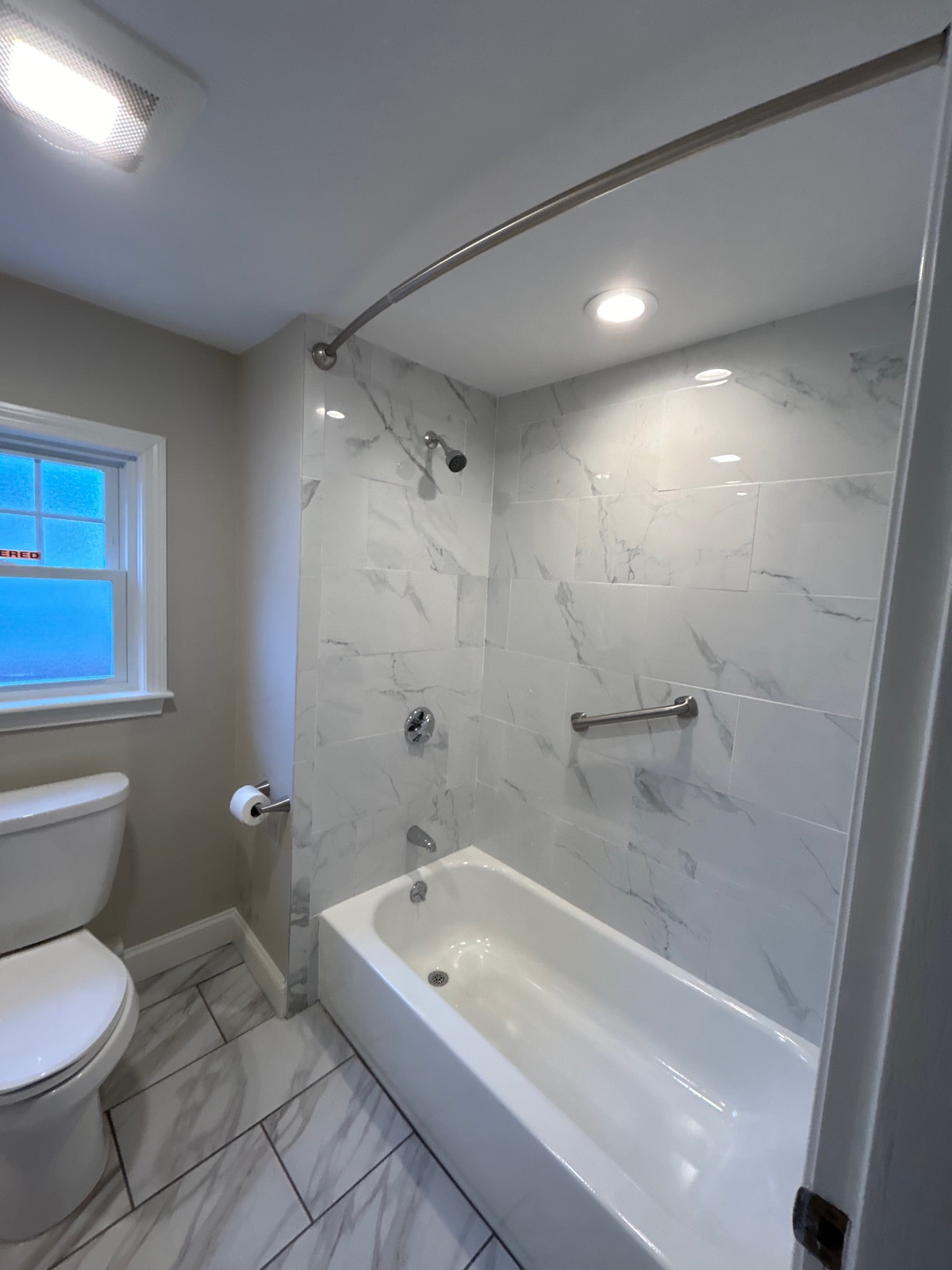 Bathroom remodel with marble tile shower and tub